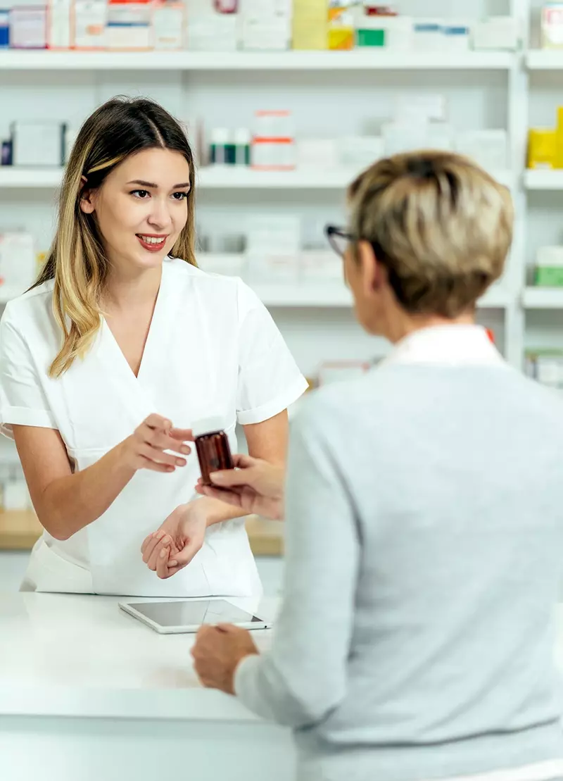 female pharmacist talking to patient